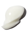 closeup of white eye cream dollop on white background