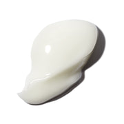 closeup of white eye cream dollop on white background