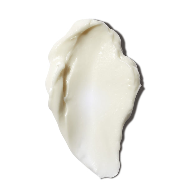closeup of smear of cream-colored skincare night cream, on white background 
