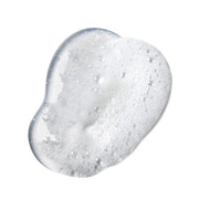 closeup of clear oil facial cleanser, with light foaming, on white background